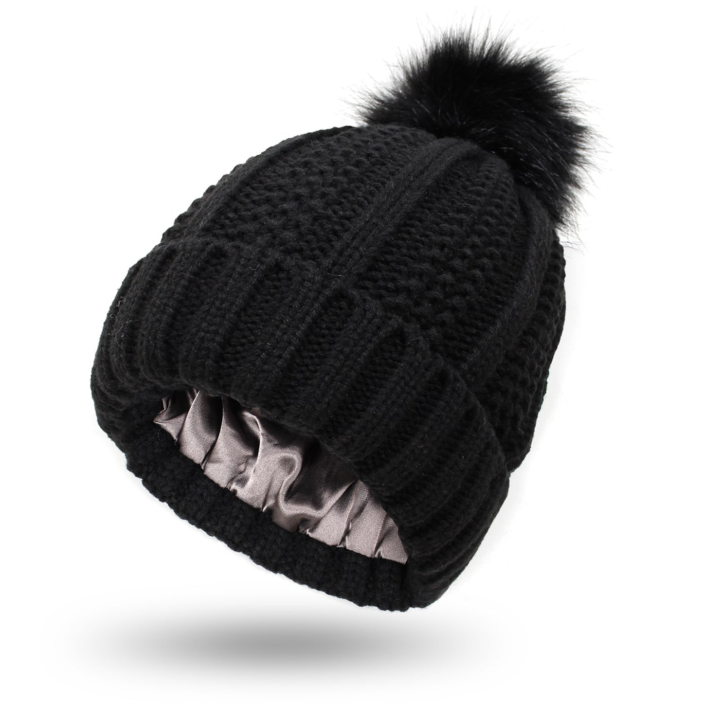 Dark gray satin lined knit beanie with plush pom pom detail, hair friendly interior to reduce frizz after long cold days