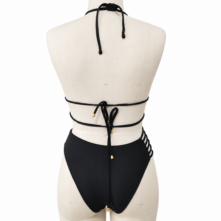 Black bikini back view on a fabric display mannequin against white, showing the halter ties, back knots and matching bottoms.