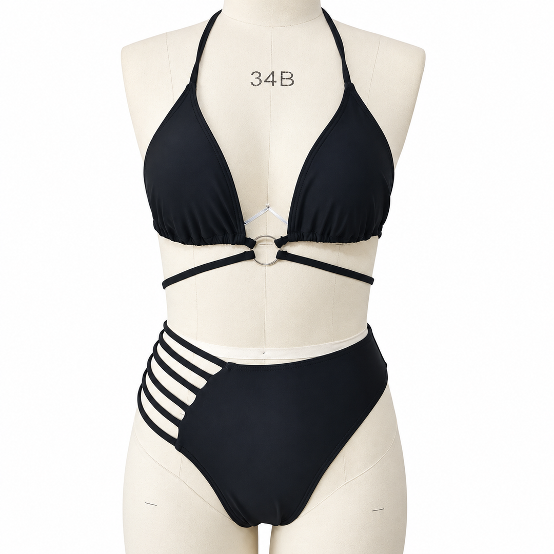 Black cutout bikini on a fabric display mannequin against white, showing the halter top, central ring and side strap details.