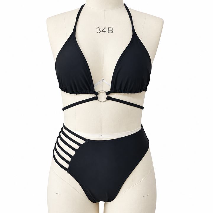 Black cutout bikini on a fabric display mannequin against white, showing the halter top, central ring and side strap details.