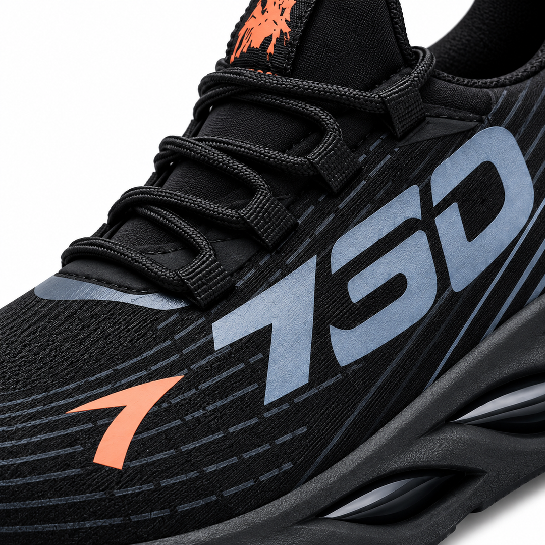 Black lace-up shoe close-up showing mesh texture, laces, side graphic and orange tongue detail