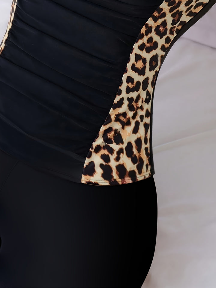 Close-up of black swimsuit top with leopard-print side panel and matching shorts