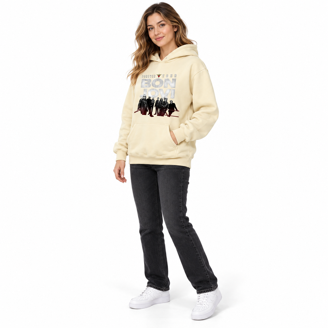Cream graphic pullover hoodie in side view on a full-length female model, showing the sleeve, hood and front kangaroo pocket.