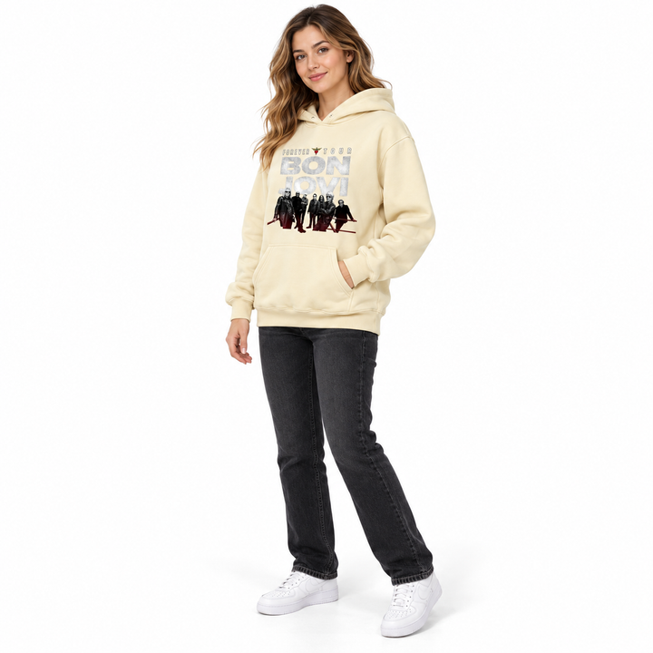 Cream graphic pullover hoodie in side view on a full-length female model, showing the sleeve, hood and front kangaroo pocket.