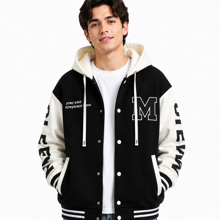 Black and white colorblock hoodie jacket close-up on male model showing chest patch, sleeve lettering and striped trim
