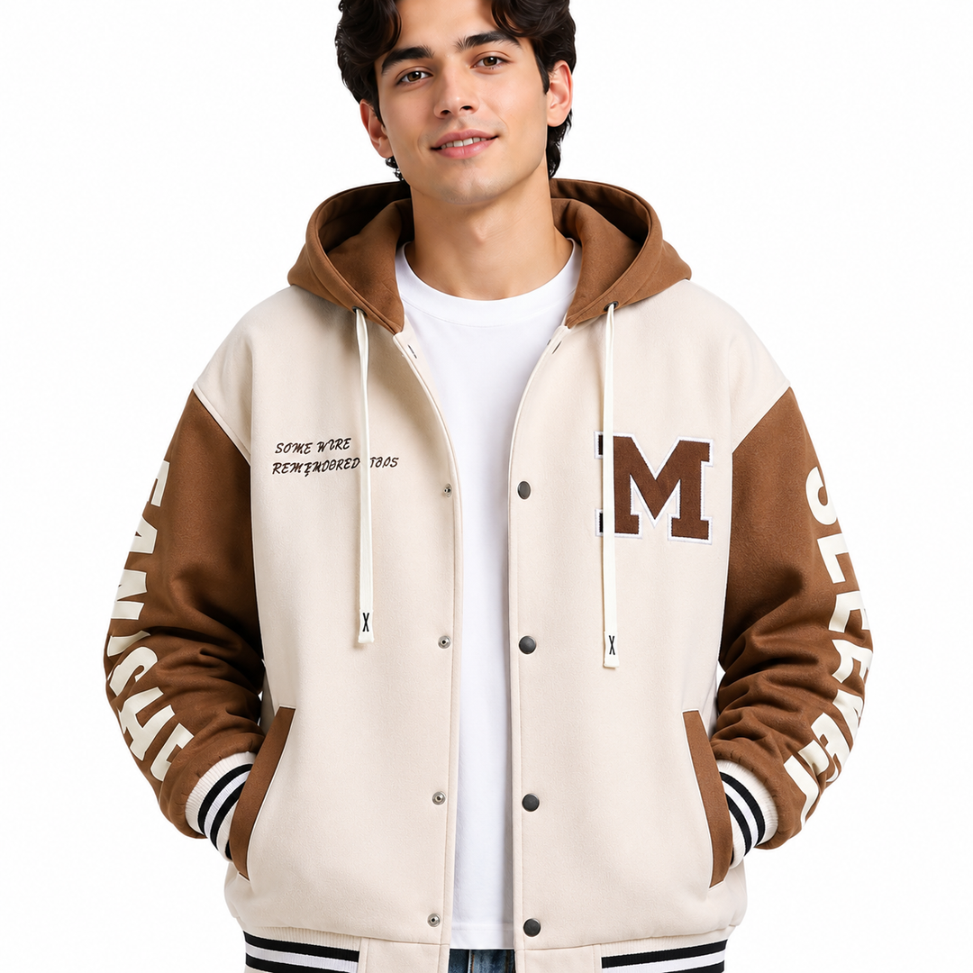 Cream and brown colorblock hoodie jacket close-up on male model showing chest patch, hood, snap buttons and striped trim