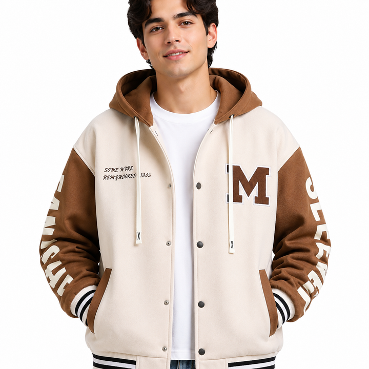 Cream and brown colorblock hoodie jacket close-up on male model showing chest patch, hood, snap buttons and striped trim