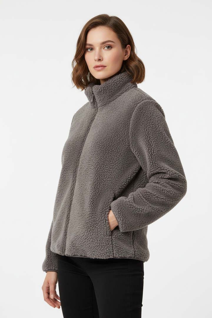 Woman wearing a gray fleece jacket on a white background
