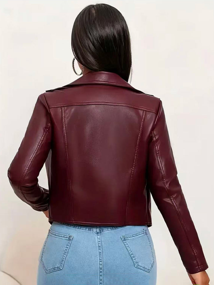 Burgundy jacket viewed from behind on a model, showing back yoke, vertical panel seams, long sleeves and short waistline hem.