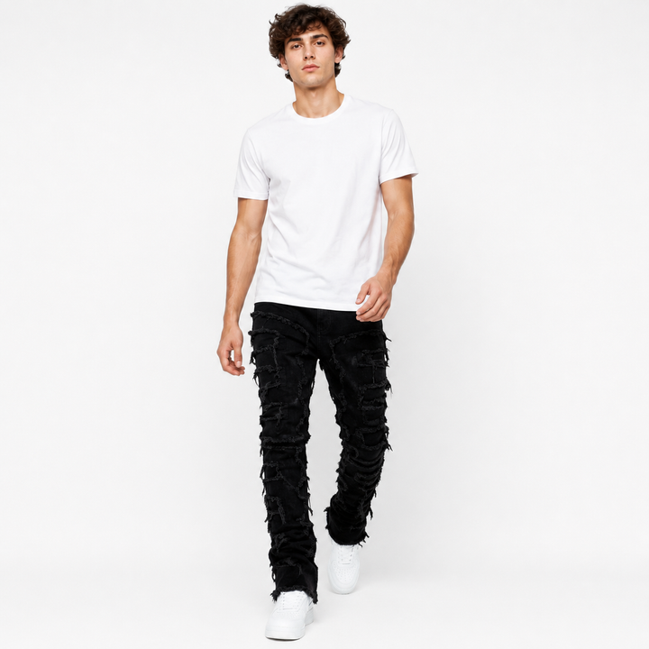 Ripped stacked jeans for men with slim fit silhouette and extended ankle stacking effect