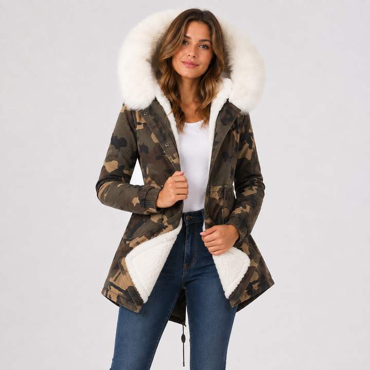 Camouflage coat hero view on a female model with white faux fur hood trim, white lining, long sleeves, and shaped waist line.