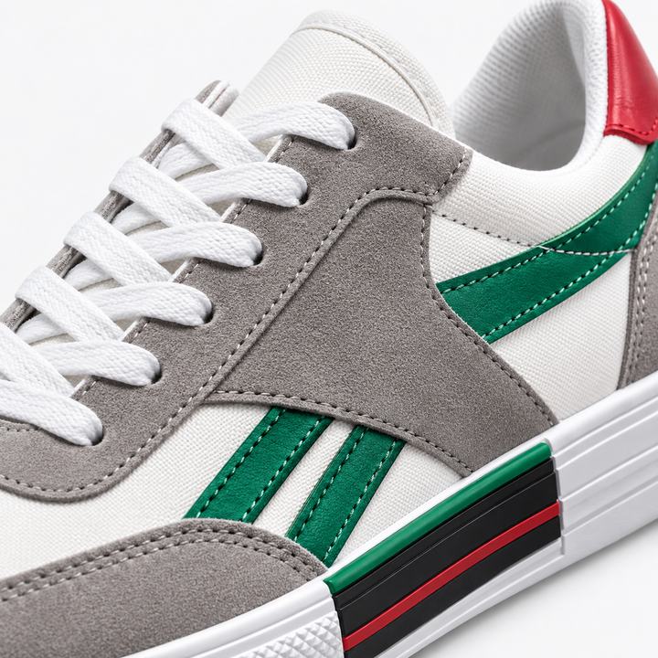 Close-up of green striped canvas shoes showing gray overlays, white laces, stitching and side sole accent detail.