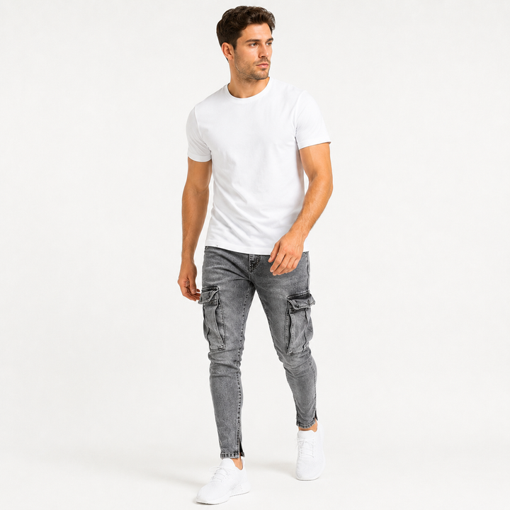 Washed gray cargo jeans for men on an adult male model in a natural walking pose, showing the tapered fit and thigh cargo pockets.