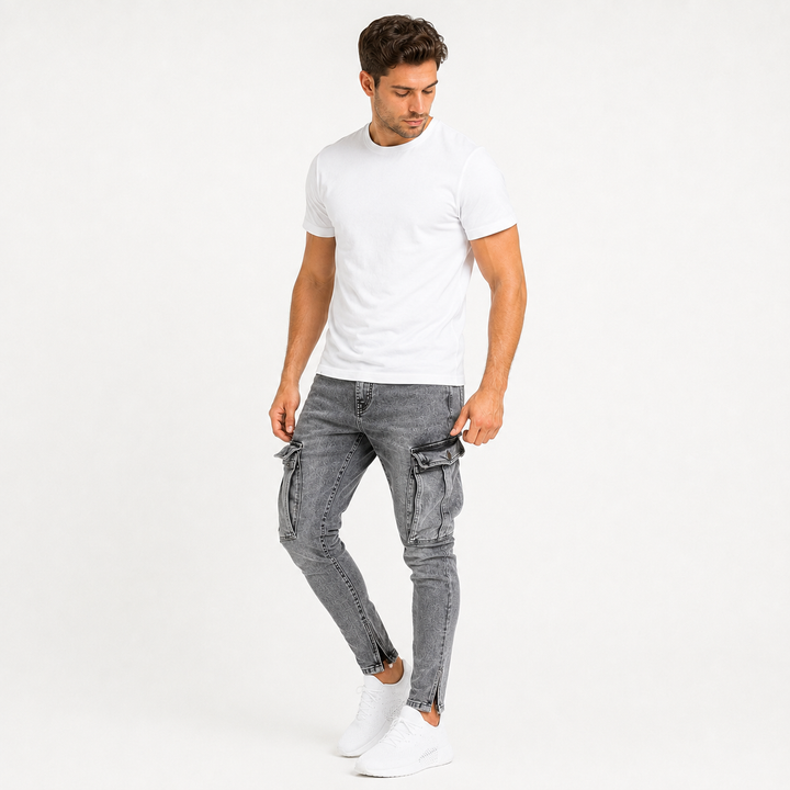Washed gray cargo jeans for men on an adult male model with focus on the large thigh cargo pockets, seam details and tapered leg shape.