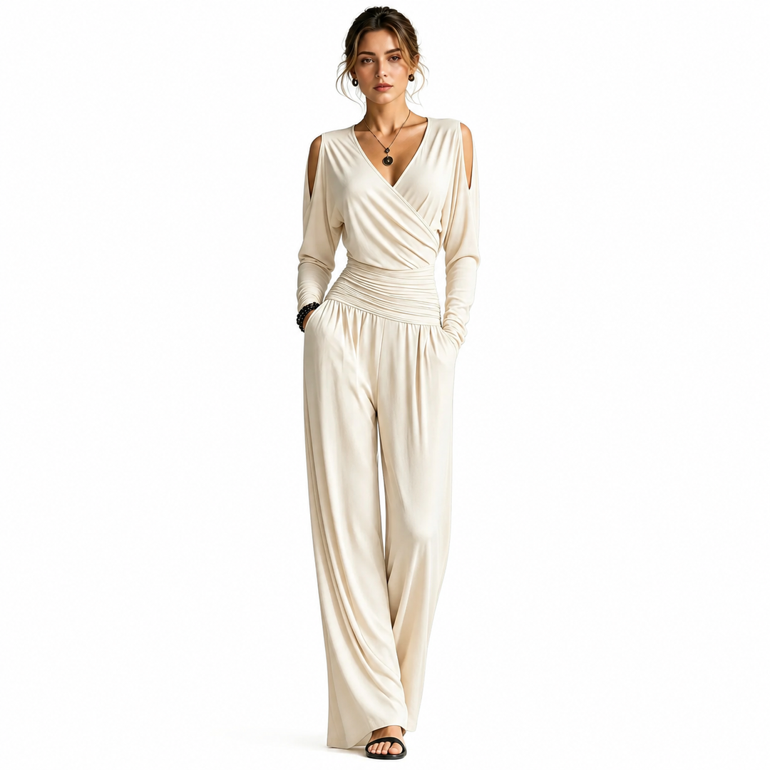 Apricot Milk Silk jumpsuit on a woman with visible face, V-neck wrap bodice, cold-shoulder sleeves, ruched waist and wide-leg pants.