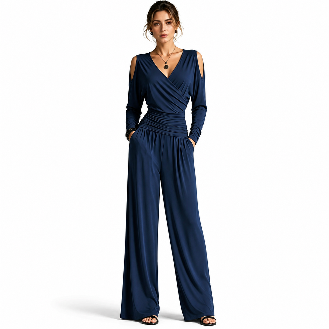 Navy Blue Milk Silk jumpsuit on a woman with visible face, wrap V-neck, cold-shoulder sleeves, ruched waist and wide-leg pants.