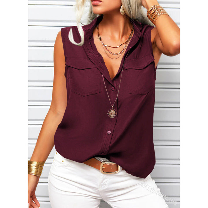 Woman wearing a burgundy sleeveless top with white pants against a white background