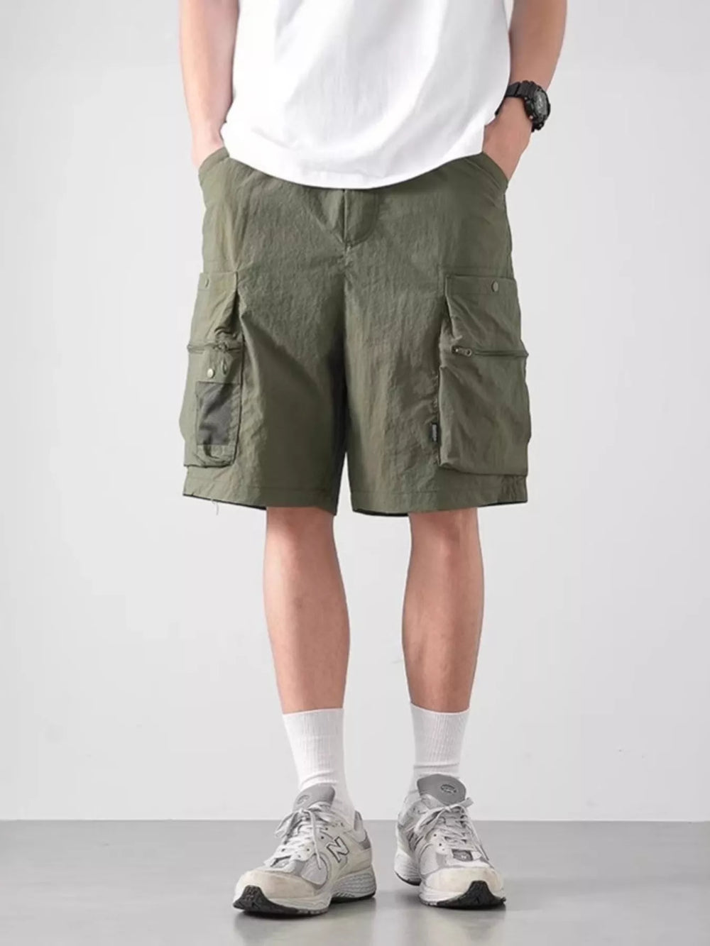 Flat lay of lightweight cargo shorts with casual tee and summer sneakers