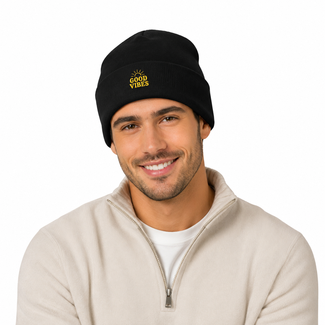 Man wearing black cuffed beanie with embroidered Good Vibes design in a clean white studio portrait