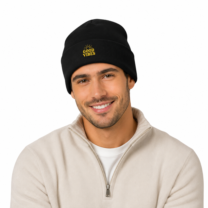 Man wearing black cuffed beanie with embroidered Good Vibes design in a clean white studio portrait