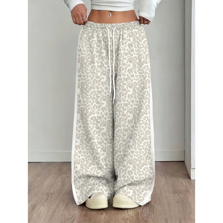 Leopard print wide-leg pants worn by a person on a wooden floor.