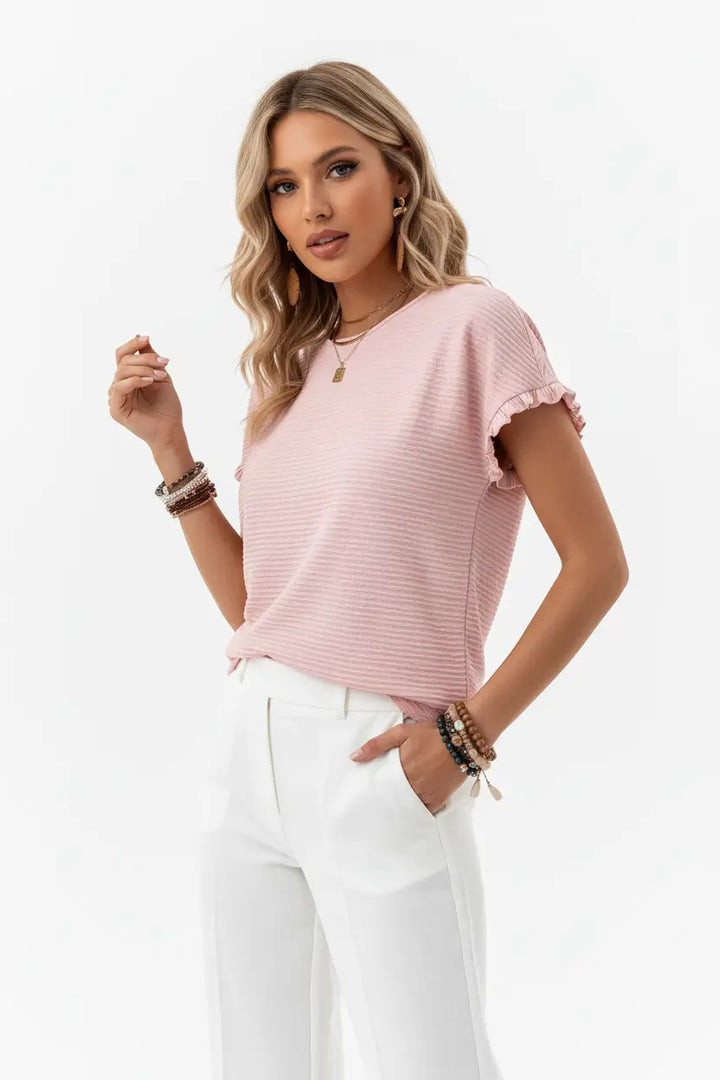 model wearing white ruffle sleeve blouse tucked into high-waisted skirt, relaxed oversized fit visible, round neck and elegant ruffle top details creating polished temperament commuting aesthetic