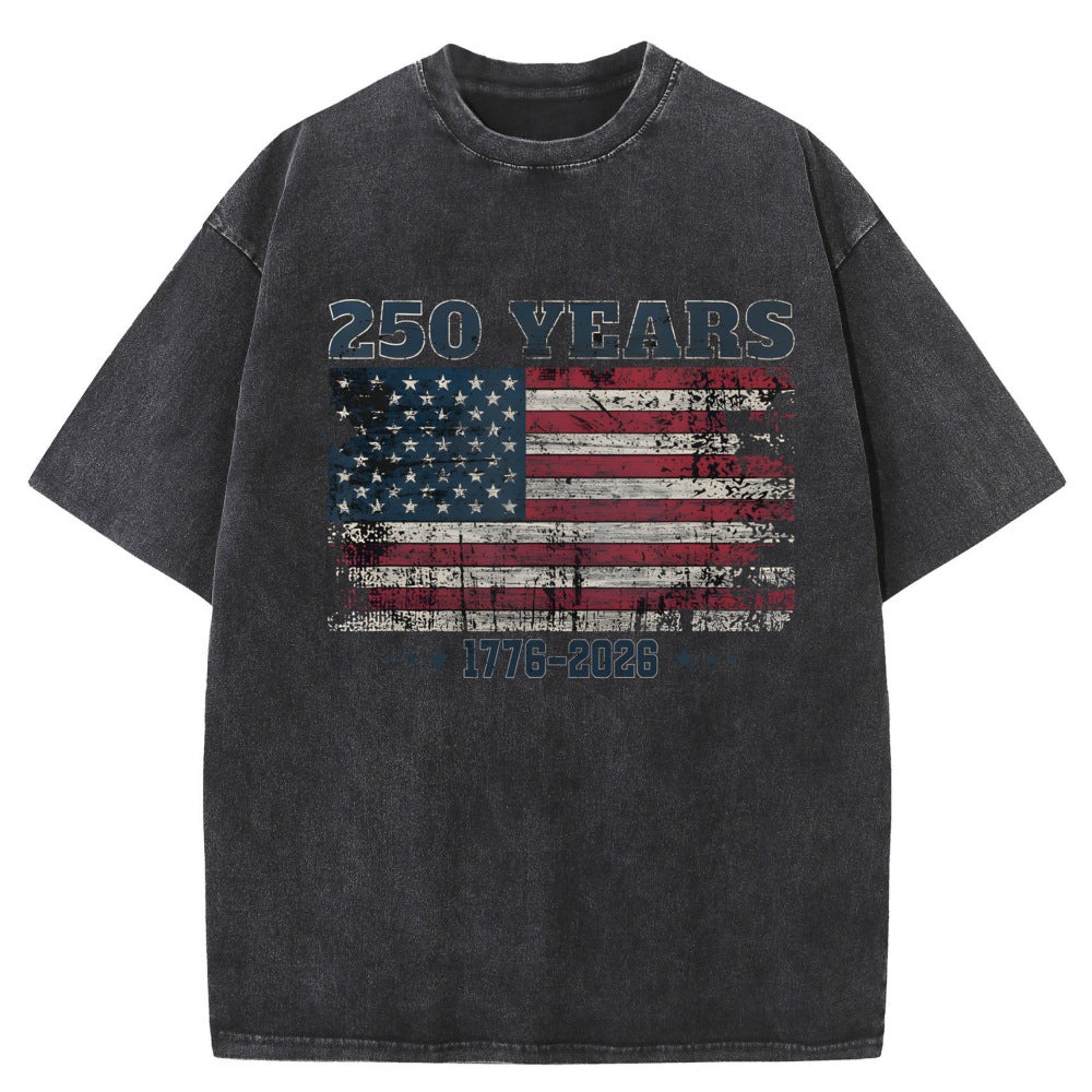 A dark gray acid-wash t-shirt featuring a distressed American flag graphic on the chest with &