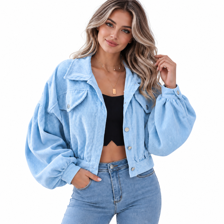 Denim Blue corduroy jacket worn by a model, showing the front construction, collar and gathered sleeves against a white background.
