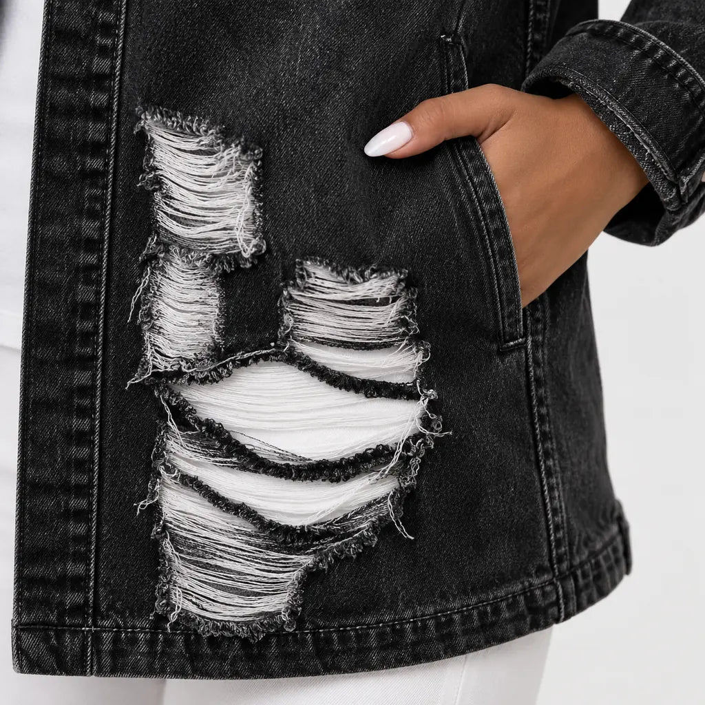 Close detail view of denim texture, seam finishing and frayed distressed sections on the women&