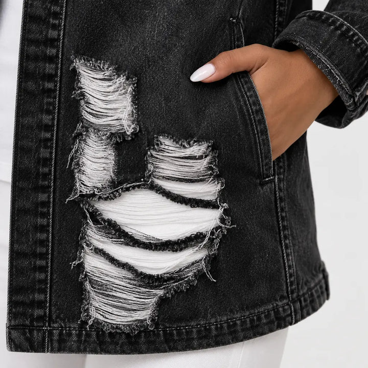 Close detail view of denim texture, seam finishing and frayed distressed sections on the women&