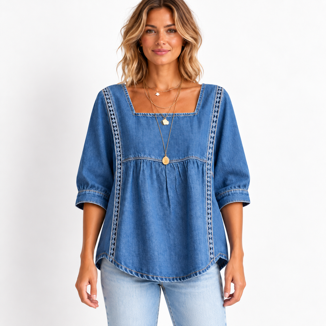 Front catalog view of the denim blouse on a model showing square neckline, regular sleeves and lace patchwork trim.