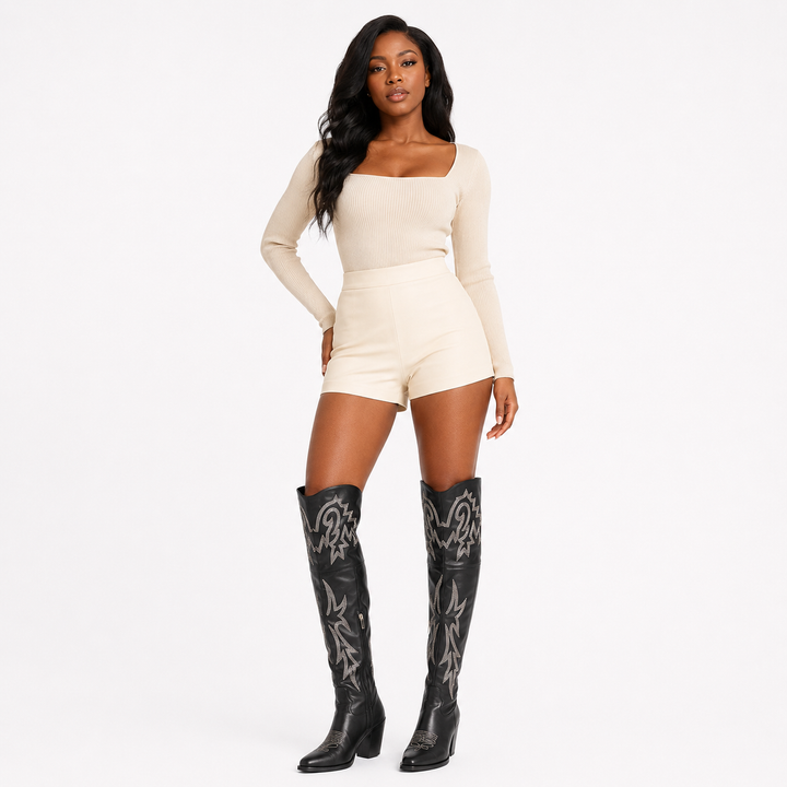 Black denim thigh high Western boots for women shown in a premium angled editorial pose on a white studio background.