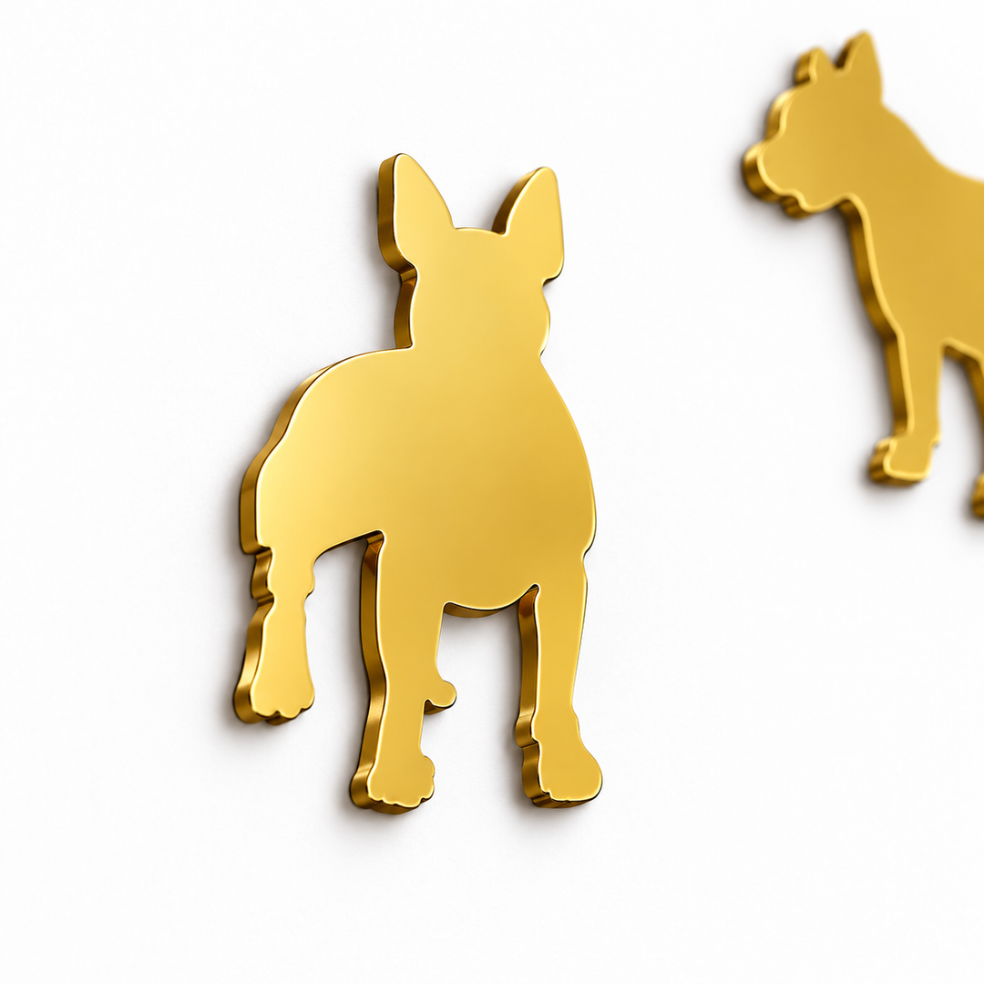 Close-up of a gold dog silhouette wall clock marker showing the reflective decorative surface and clean cutout shape.