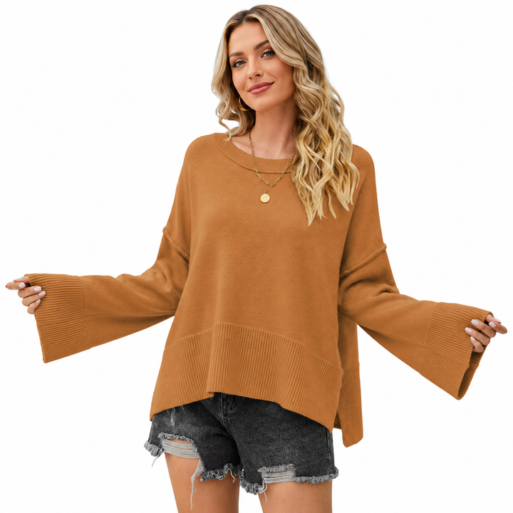 Camel flare sleeve sweater on a woman with dropped shoulders, wide ribbed cuffs and relaxed knit styling on a white studio background