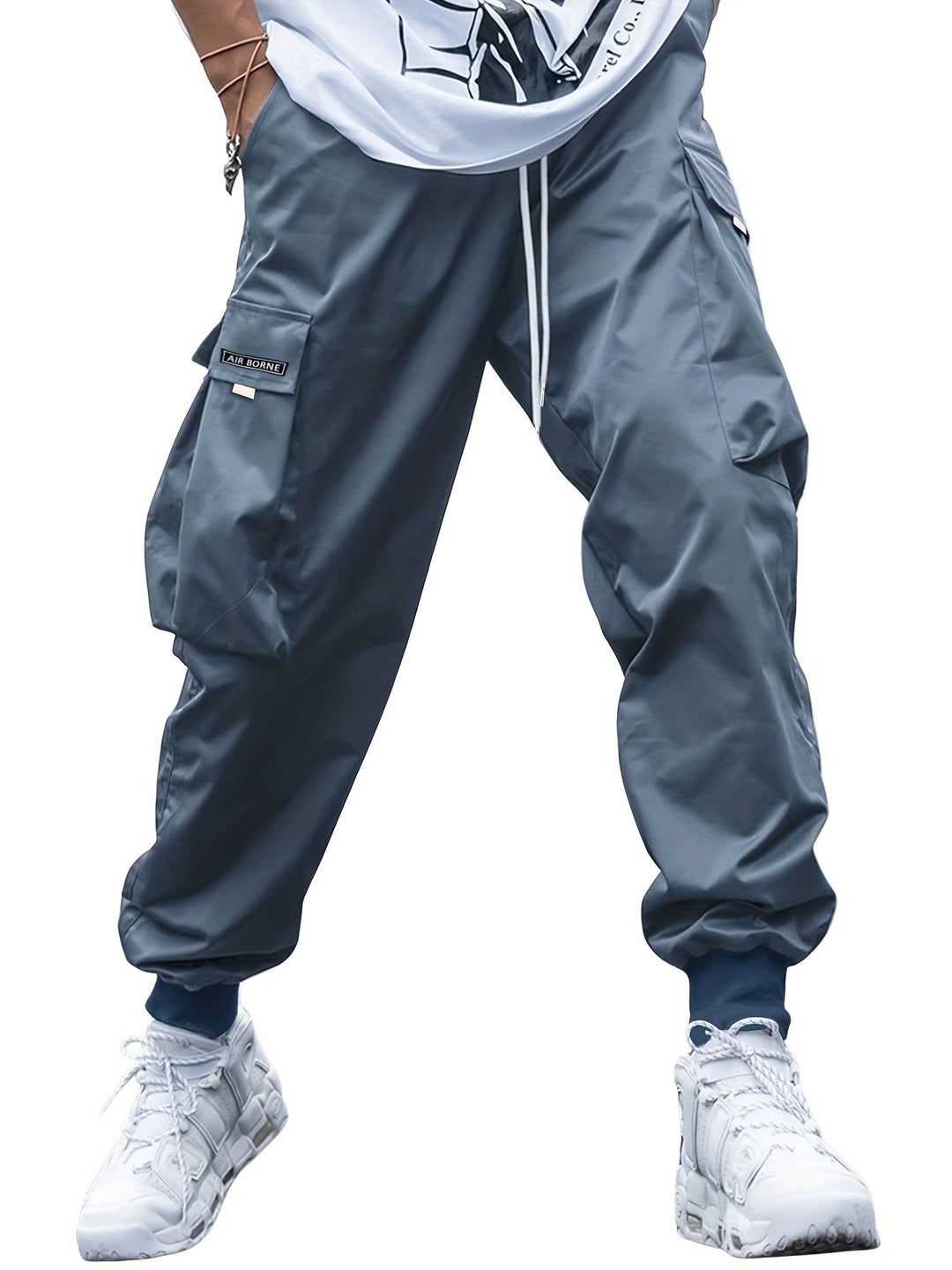 Gray cargo pants worn by a person on a white background