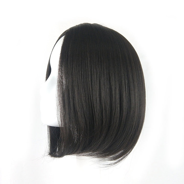 Close-up of short wig hairline and smooth texture in dark brown shade