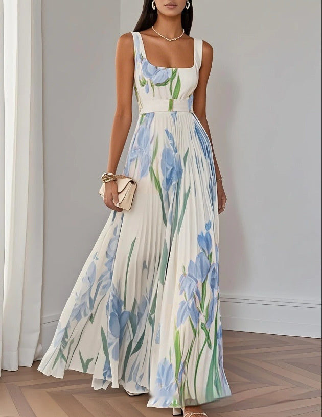 Woman wearing a floral dress with blue flowers in a minimal indoor setting