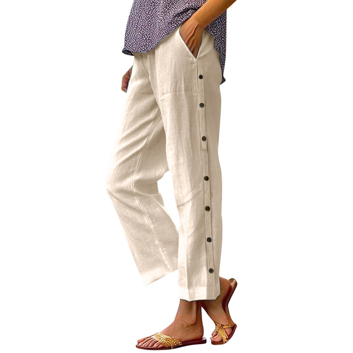 Beige pants with buttons worn by a person on a white background