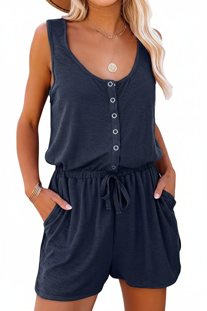Woman wearing a navy blue romper with a white background