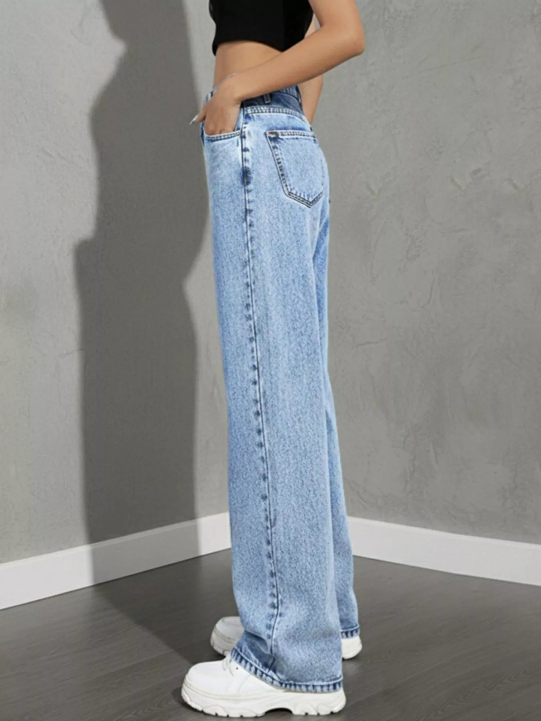 high rise wide leg jeans close-up of button closure and waistband stitching light wash rigid denim for structured fit
