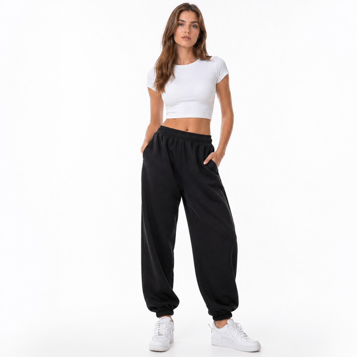 Model wearing lightweight jogger pants with elastic waist, side pockets and sporty relaxed fit