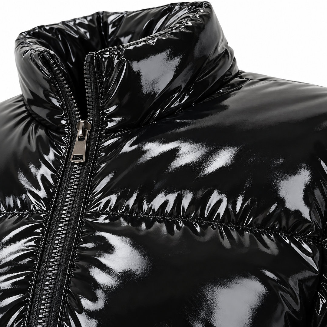 Close-up of the glossy black surface, padded seams and stand collar.