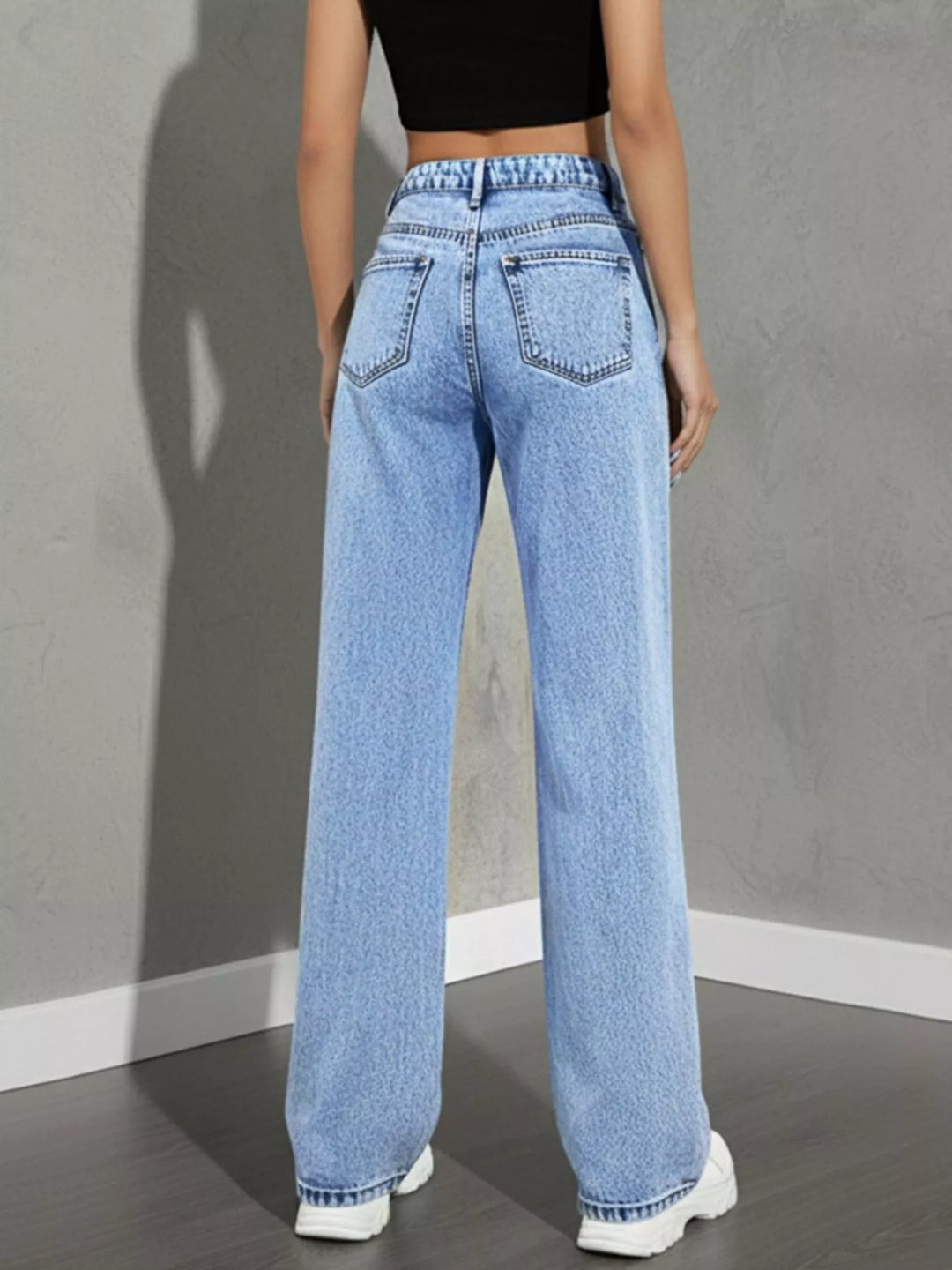 high rise wide leg jeans outfit flat lay with black crop top and light wash denim for minimalist quiet luxury styling
