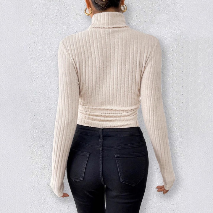 long sleeve high neck bodysuit front view in apricot, slim fit jumpsuit-style body for clean minimal outfits
