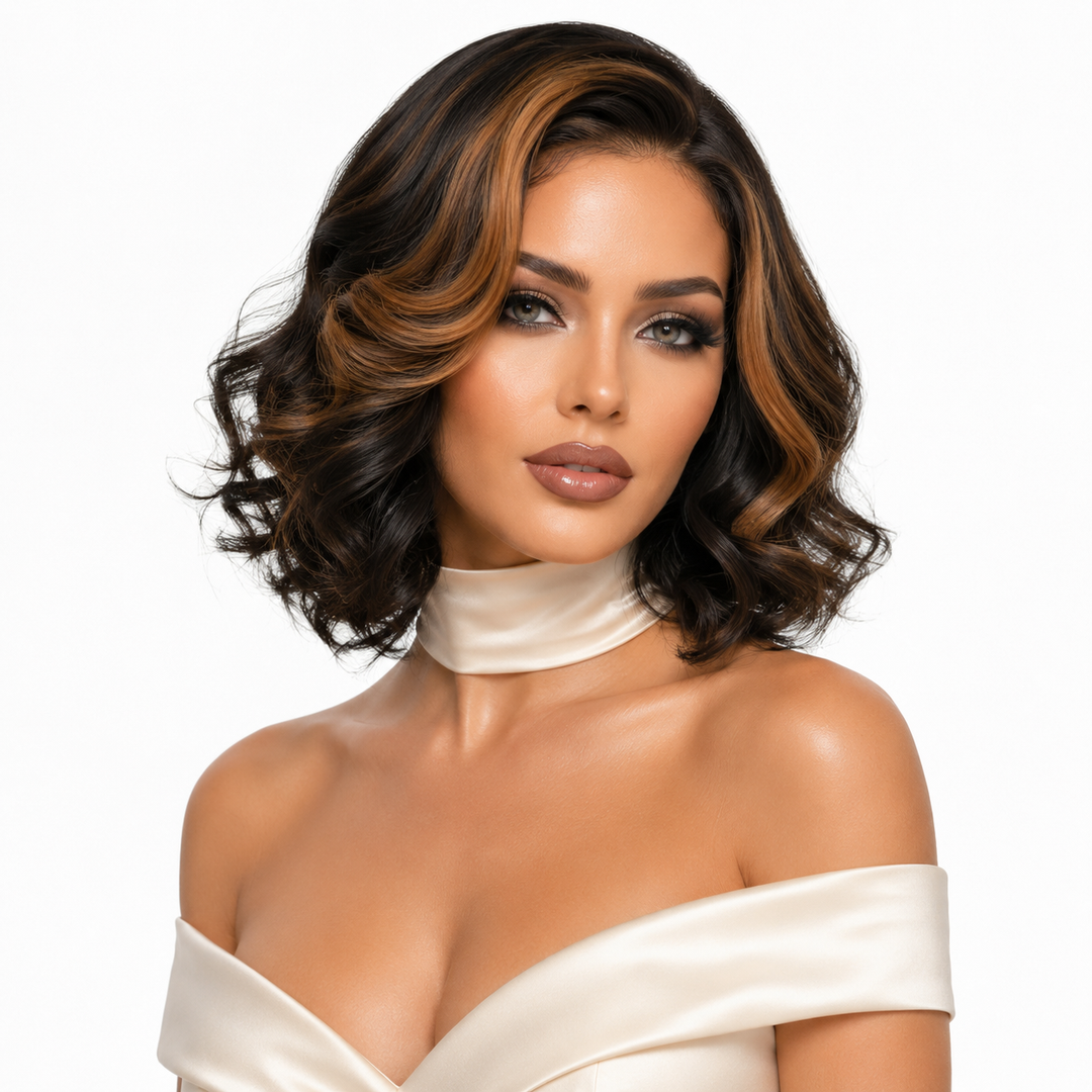 A woman with a short, wavy dark brown wig with warm caramel highlights, styled with a high-impact center part, wearing a cream satin choker and off-the-shoulder top against a plain white background.