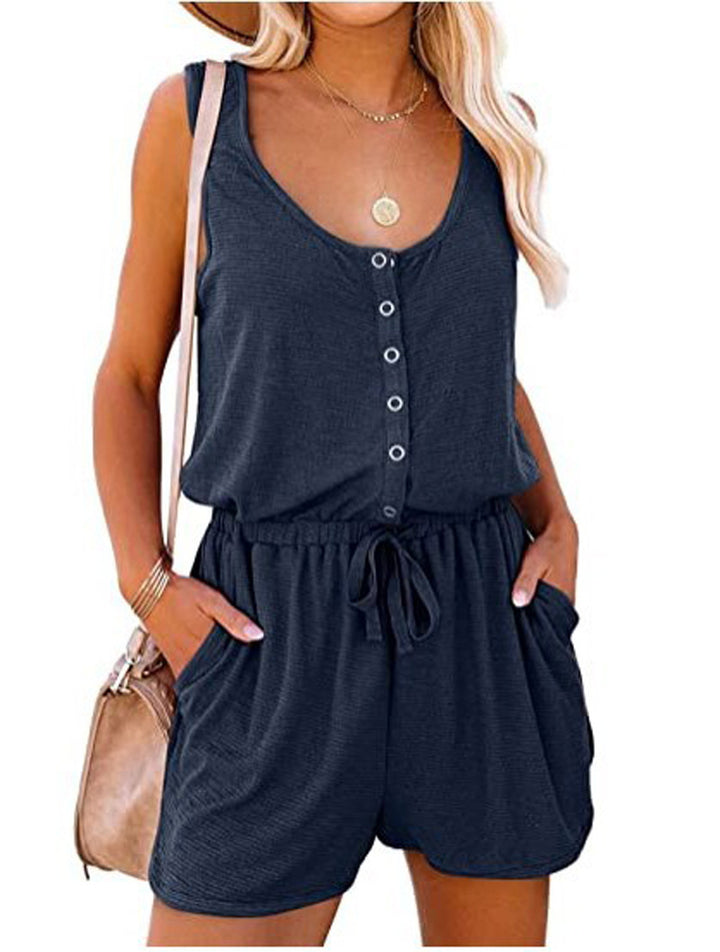 Woman wearing a navy blue romper with a white background