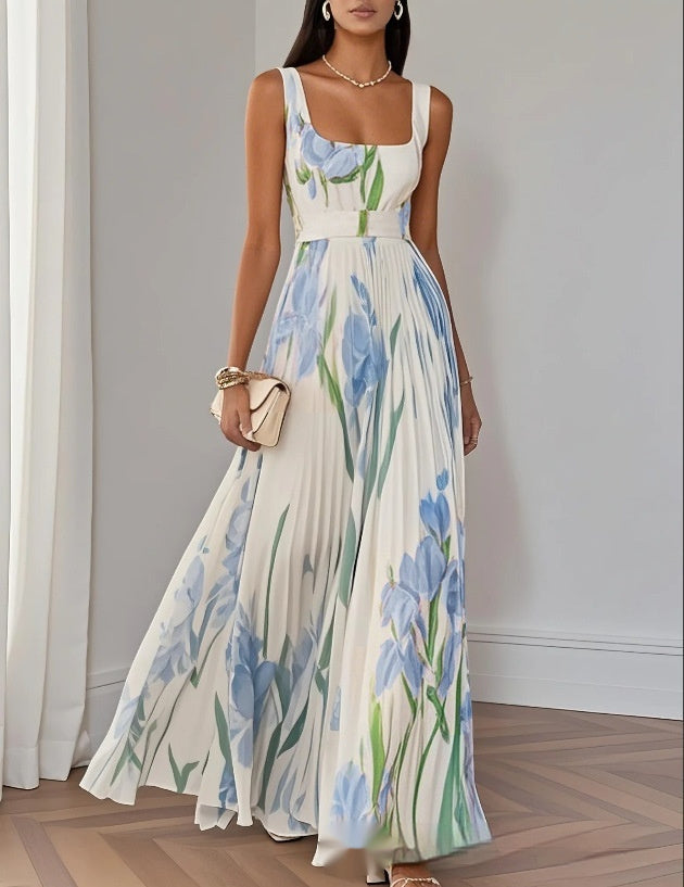Woman wearing a floral dress with blue flowers indoors.