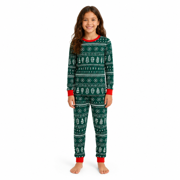 Girl wearing green Christmas pajamas with white festive motifs and red trim on a white studio background.