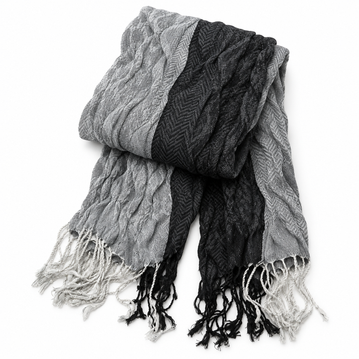 Jacquard scarf folded to show its woven panels, texture and fringed ends.