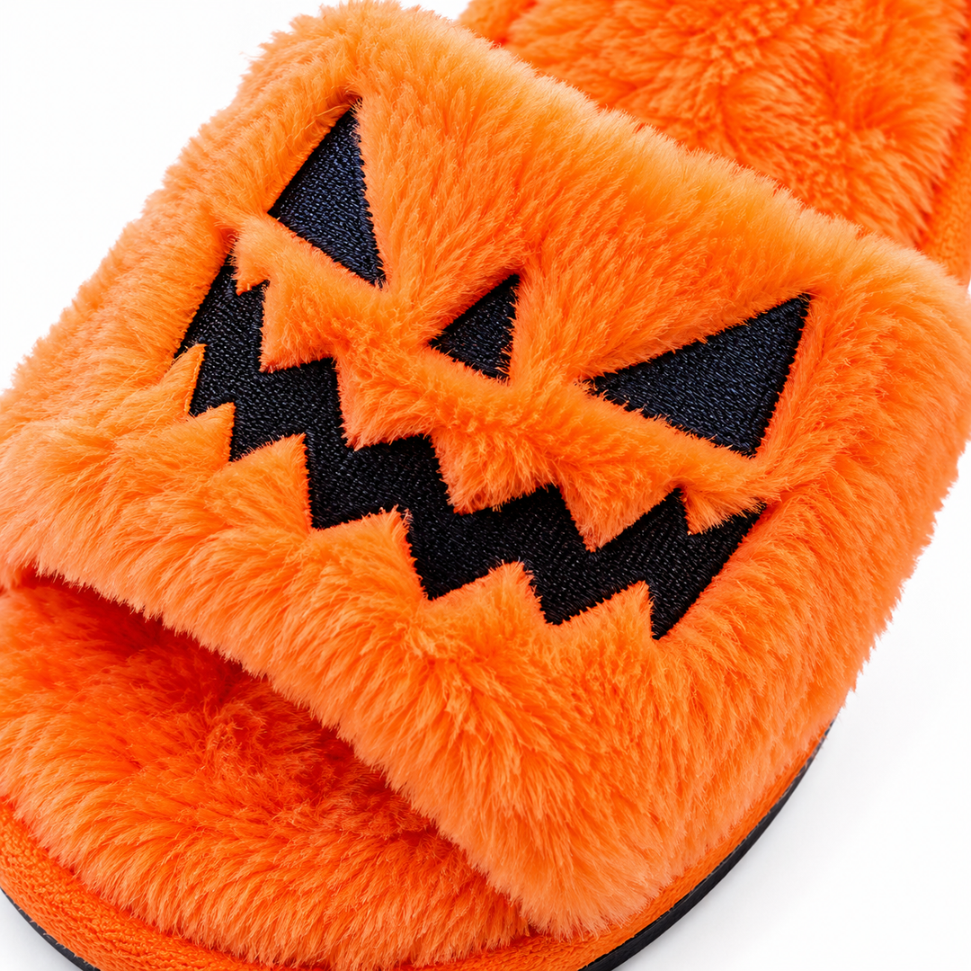 Close-up of orange plush Halloween slipper texture and jack-o&